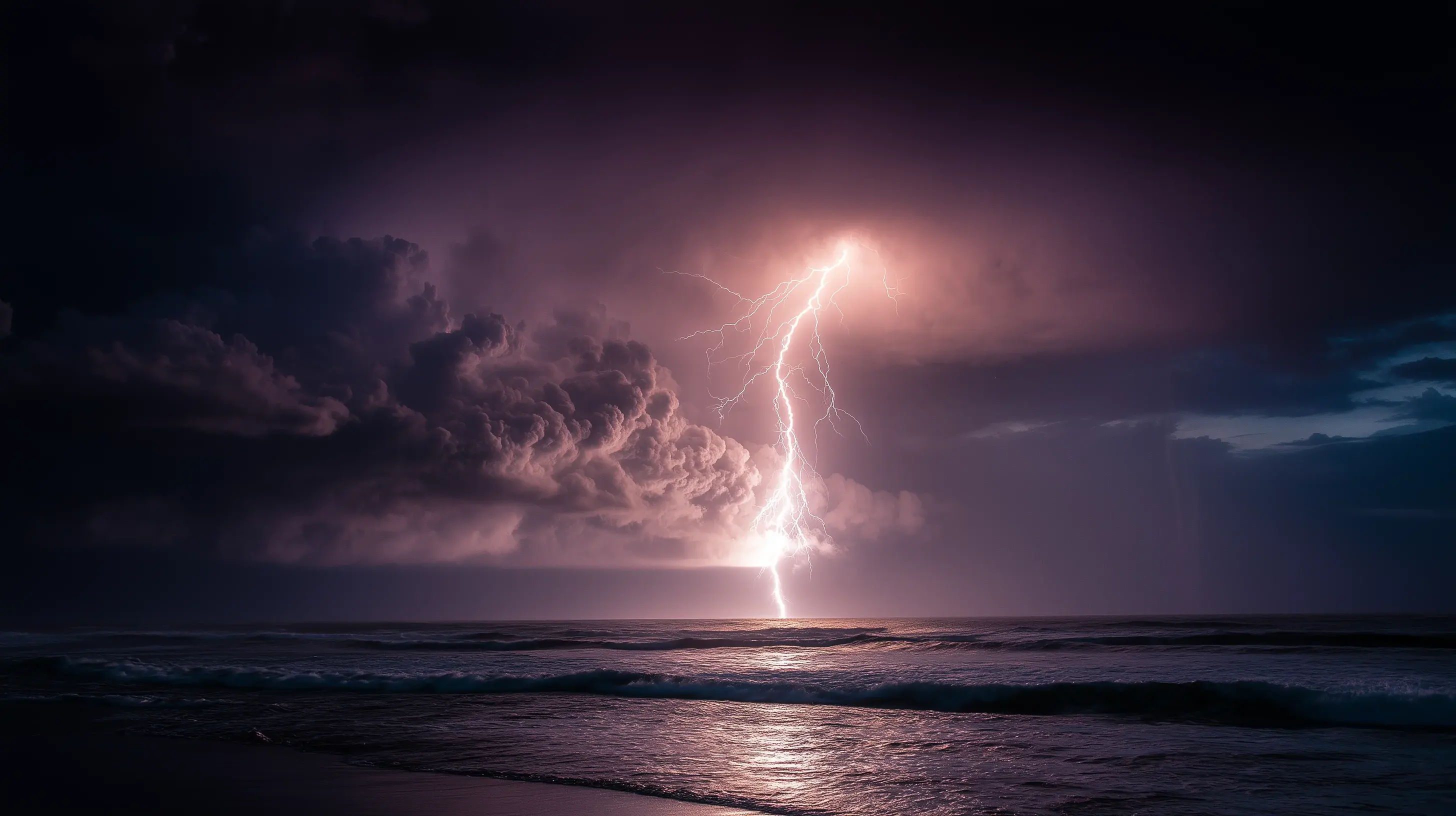 Lightning striking the ocean at night